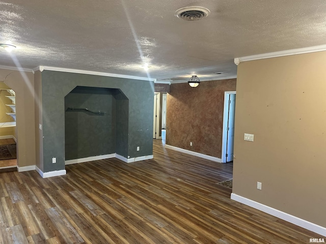 104 Mcneil St, Energy, IL 62933 - empty room with a textured ceiling, ornamental molding, wood finished floors, and arched walkways
