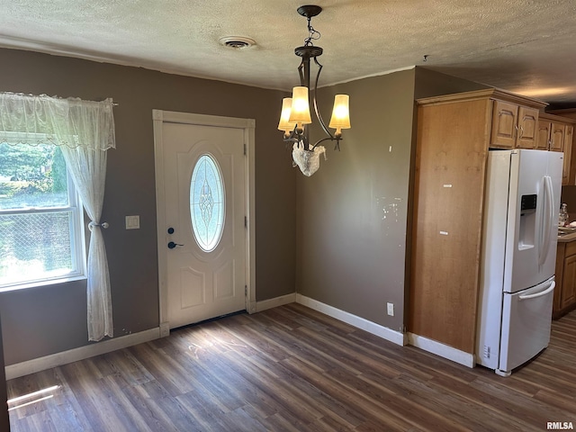 104 Mcneil St, Energy, IL 62933 - entryway featuring dark wood finished floors, a textured ceiling, and a chandelier