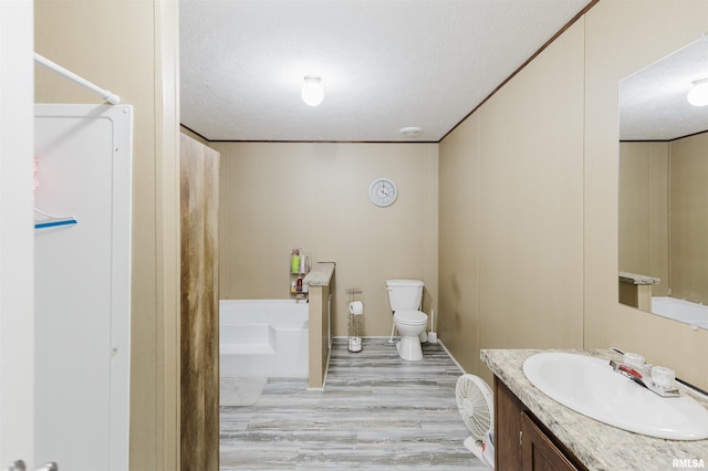11149 Crenshaw Rd, Marion, IL 62922 - bathroom featuring a textured ceiling, a tub to relax in, vanity, wood finished floors, and a shower
