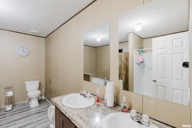11149 Crenshaw Rd, Marion, IL 62922 - full bath with a textured ceiling, wood finished floors, double vanity, and a shower