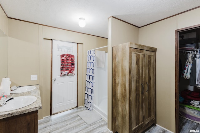 11149 Crenshaw Rd, Marion, IL 62922 - full bathroom with ornamental molding, wood finished floors, a shower with curtain, double vanity, and a textured ceiling