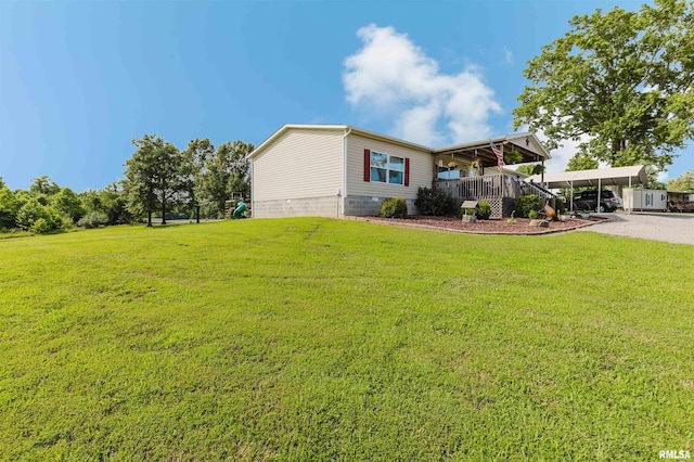 11149 Crenshaw Rd, Marion, IL 62922 - view of green lawn featuring a porch, driveway, and a carport