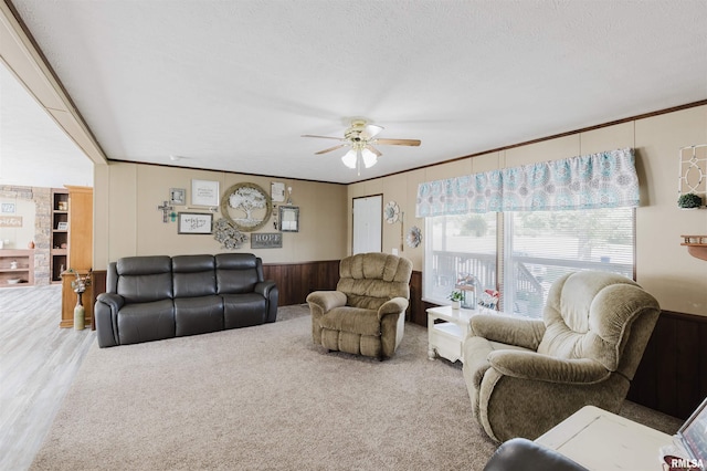 11149 Crenshaw Rd, Marion, IL 62922 - living room with a ceiling fan, crown molding, wooden walls, a textured ceiling, and wood finished floors