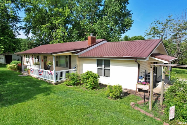 4139 Altenberger Rd, Metropolis, IL 62960 - rear view of property with covered porch, a lawn, a chimney, and a metal roof