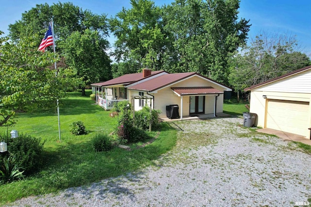 4139 Altenberger Rd, Metropolis, IL 62960 - bungalow-style home with a front lawn, a garage, a chimney, and driveway