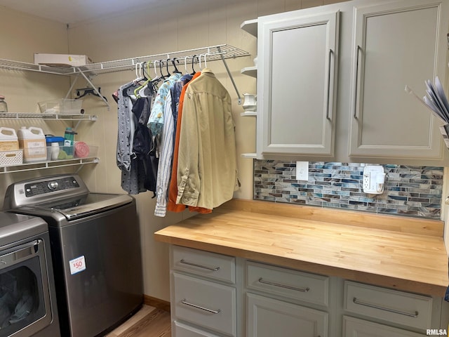 4139 Altenberger Rd, Metropolis, IL 62960 - washroom with separate washer and dryer, cabinet space, and wood finished floors