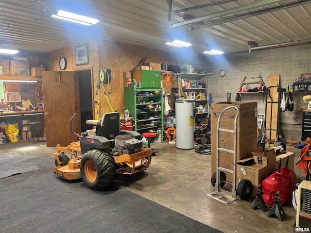 4139 Altenberger Rd, Metropolis, IL 62960 - garage featuring gas water heater, a workshop area, and concrete block wall