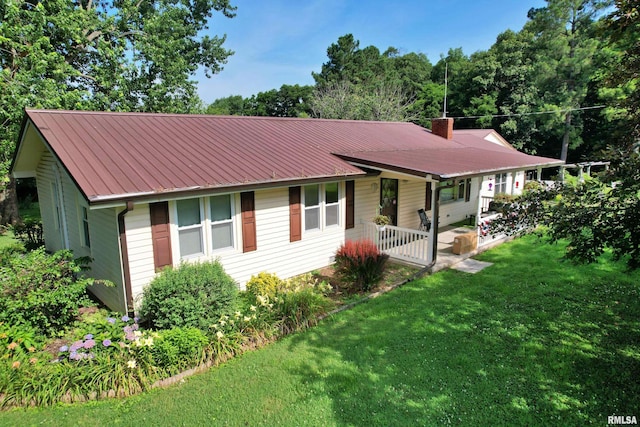 4139 Altenberger Rd, Metropolis, IL 62960 - ranch-style home with a front yard, a metal roof, a chimney, and covered porch