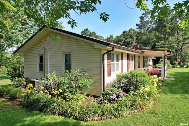 4139 Altenberger Rd, Metropolis, IL 62960 - view of side of home with a yard, a porch, and a chimney