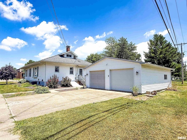 202 Flora Ave, Flora, IL 62839 - view of front facade featuring a detached garage, a front yard, an outbuilding, and a chimney