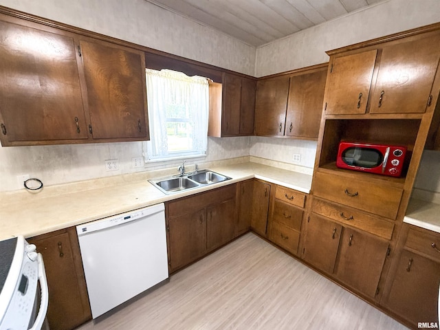 202 Flora Ave, Flora, IL 62839 - kitchen with white dishwasher, range, light wood finished floors, and light countertops