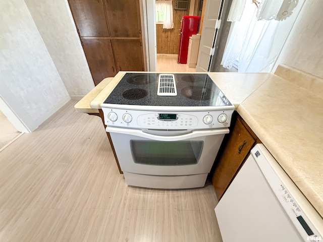 202 Flora Ave, Flora, IL 62839 - kitchen featuring white appliances, light countertops, and light wood-type flooring
