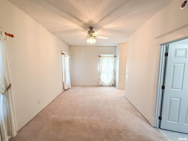 202 Flora Ave, Flora, IL 62839 - empty room featuring light carpet, ceiling fan, and a textured ceiling