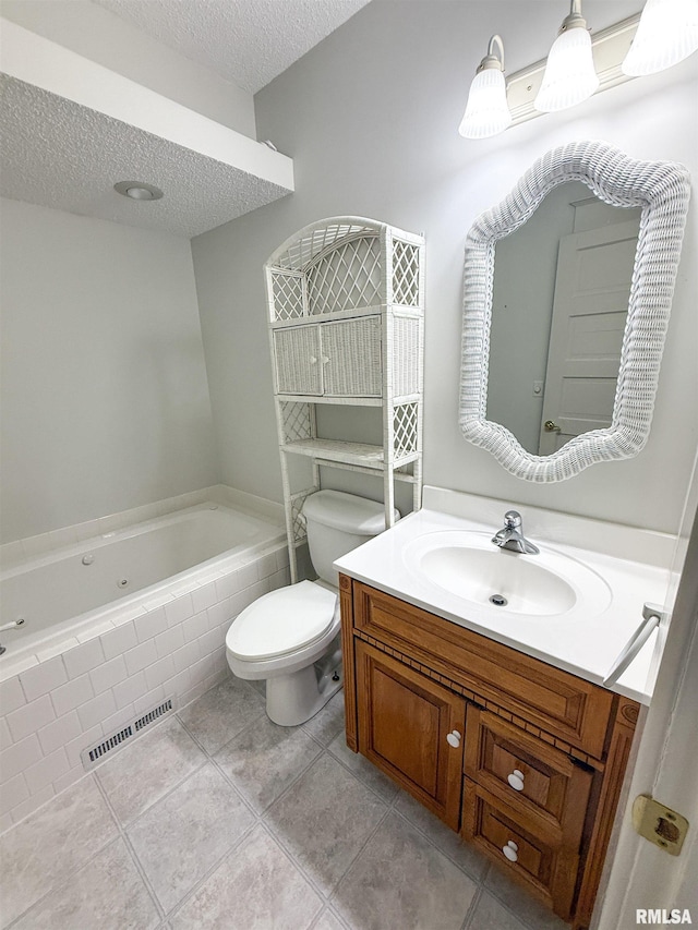 202 Flora Ave, Flora, IL 62839 - bathroom featuring a whirlpool tub, a textured ceiling, vanity, and tile patterned floors