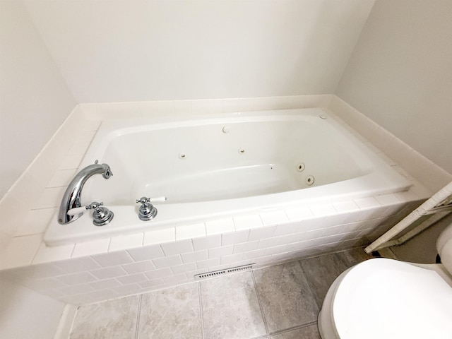 202 Flora Ave, Flora, IL 62839 - bathroom featuring a tub with jets and toilet
