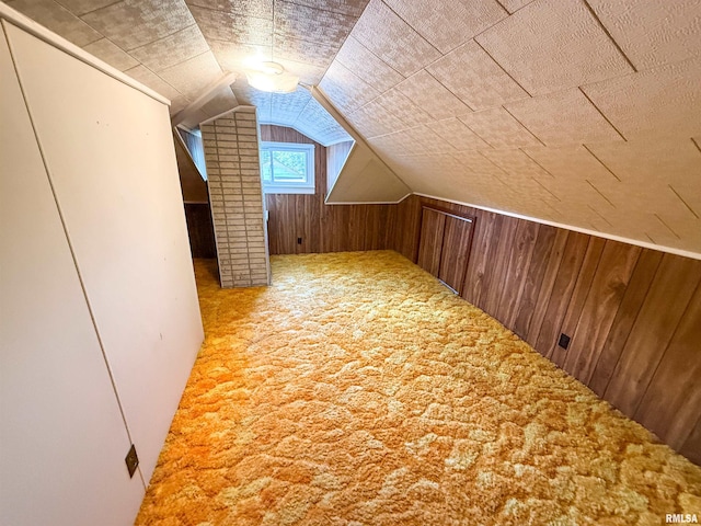 202 Flora Ave, Flora, IL 62839 - additional living space featuring wood walls, vaulted ceiling, and carpet