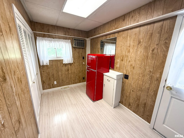 202 Flora Ave, Flora, IL 62839 - laundry area featuring washer and clothes dryer, wooden walls, a wall unit AC, and light wood-style floors
