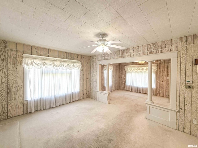 202 Flora Ave, Flora, IL 62839 - carpeted empty room featuring healthy amount of natural light, a ceiling fan, and decorative columns
