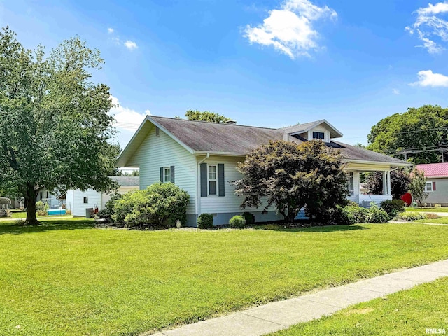 202 Flora Ave, Flora, IL 62839 - view of front of house featuring a front lawn and a shingled roof