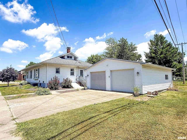 202 Flora Ave, Flora, IL 62839 - view of front of property featuring a garage, a front lawn, and an outdoor structure