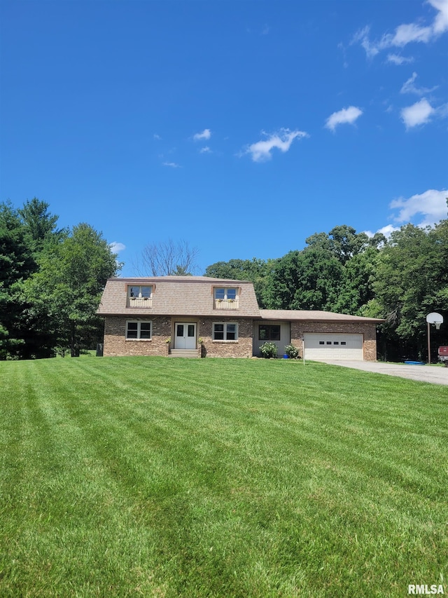 11968 E Goshen Meadows Rd, Mount Vernon, IL 62864 - view of front of house featuring an attached garage, a front yard, concrete driveway, brick siding, and french doors