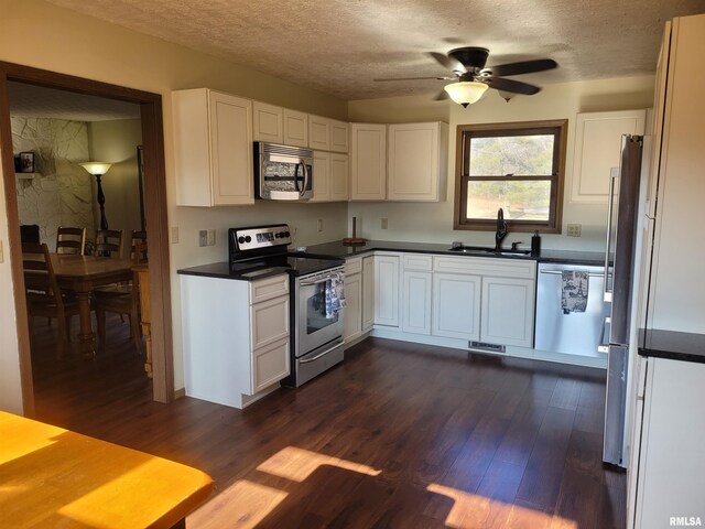 11968 E Goshen Meadows Rd, Mount Vernon, IL 62864 - kitchen featuring stainless steel appliances, a textured ceiling, dark wood-style floors, dark countertops, and white cabinets