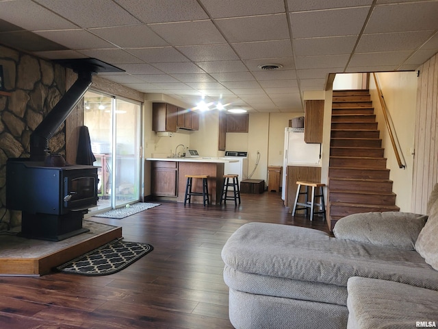 11968 E Goshen Meadows Rd, Mount Vernon, IL 62864 - living area with stairs, dark wood-style floors, washer / dryer, a drop ceiling, and a wood stove