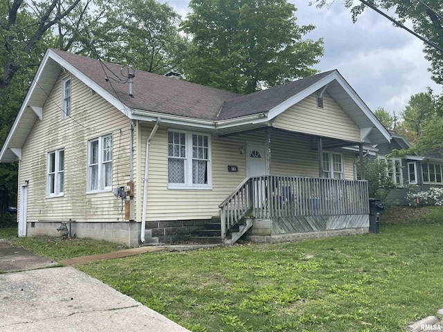 303 S Forest Ave, Carbondale, IL 62901 - view of front facade featuring a front yard, covered porch, and a shingled roof