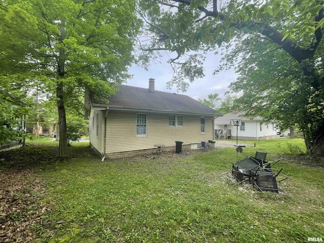 303 S Forest Ave, Carbondale, IL 62901 - rear view of property with a yard and a chimney