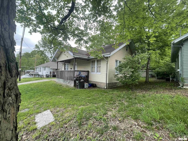 303 S Forest Ave, Carbondale, IL 62901 - view of property exterior featuring covered porch, a yard, and roof with shingles
