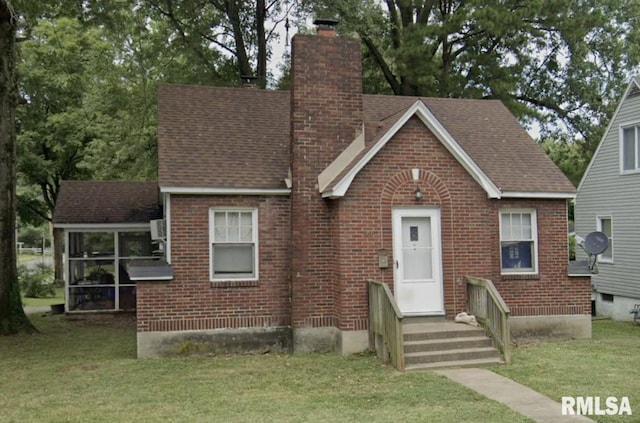 300 N Oakland Ave, Carbondale, IL 62901 - view of front of home featuring a chimney, brick siding, and a front lawn