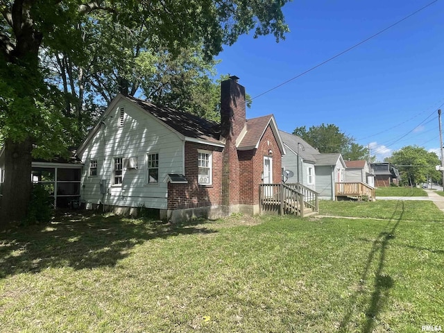 300 N Oakland Ave, Carbondale, IL 62901 - rear view of house with a chimney and a lawn
