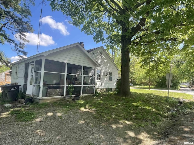 300 N Oakland Ave, Carbondale, IL 62901 - view of side of property with a sunroom, a chimney, and a lawn