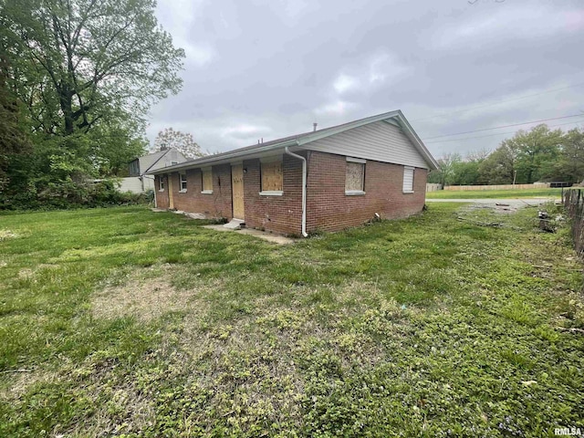 703 W High St, Carbondale, IL 62901 - view of side of property with brick siding and a lawn