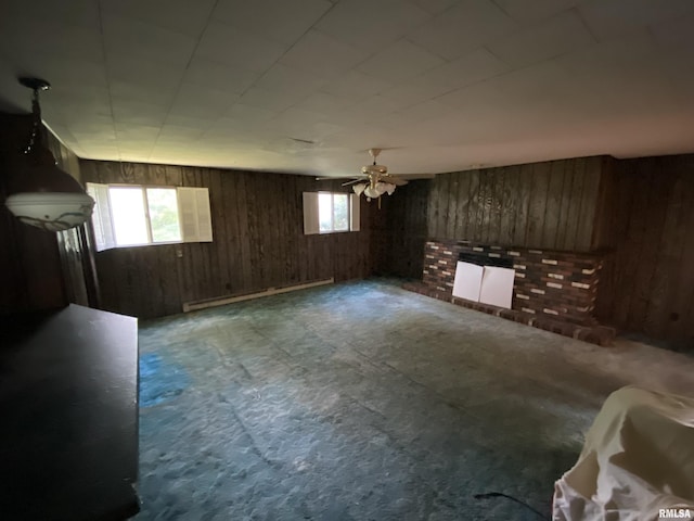 333 S Hickory St, Centralia, IL 62801 - unfurnished living room featuring wood walls, a baseboard radiator, a ceiling fan, and radiator heating unit