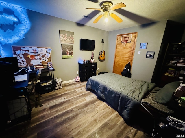 348 Medlin Rd, Walnut Hill, IL 62893 - bedroom featuring wood finished floors, a ceiling fan, and a textured ceiling