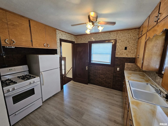 2500 Perkins Ave, Mount Vernon, IL 62864 - kitchen with white appliances, a ceiling fan, light wood-type flooring, light countertops, and brick wall