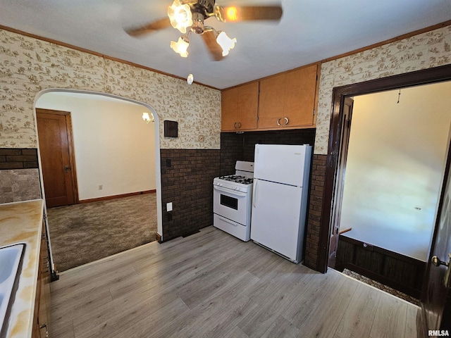 2500 Perkins Ave, Mount Vernon, IL 62864 - kitchen featuring white appliances, ceiling fan, wallpapered walls, light wood-style flooring, and arched walkways