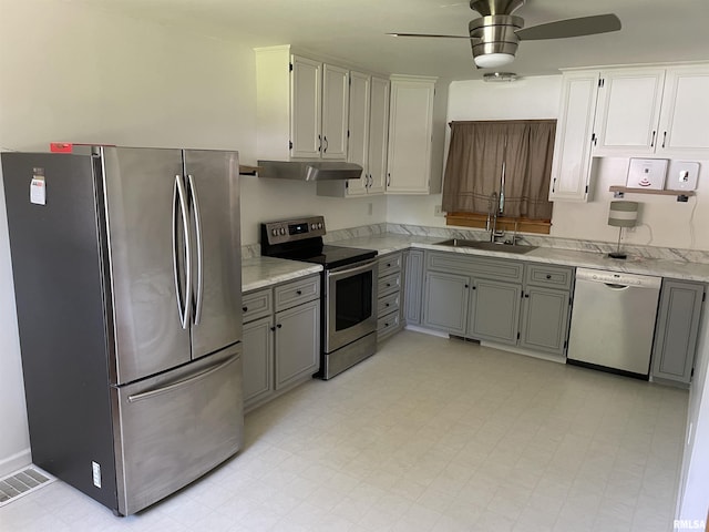 304 S Plover Dr, Carbondale, IL 62901 - kitchen with appliances with stainless steel finishes, under cabinet range hood, a ceiling fan, gray cabinetry, and light flooring