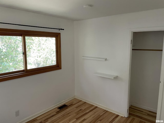 304 S Plover Dr, Carbondale, IL 62901 - unfurnished bedroom with light wood-style flooring and a closet