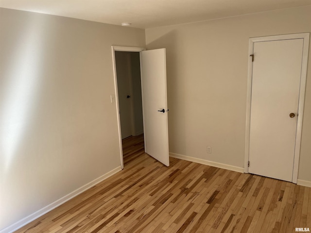 304 S Plover Dr, Carbondale, IL 62901 - unfurnished bedroom with light wood-style flooring and baseboards