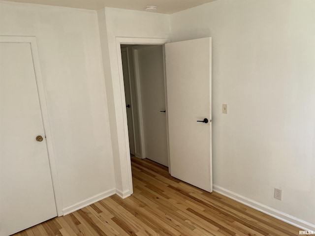 304 S Plover Dr, Carbondale, IL 62901 - unfurnished bedroom with light wood-type flooring and baseboards