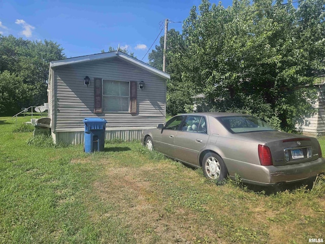 120 E 1st St, Bonnie, IL 62816 - view of side of home featuring a lawn