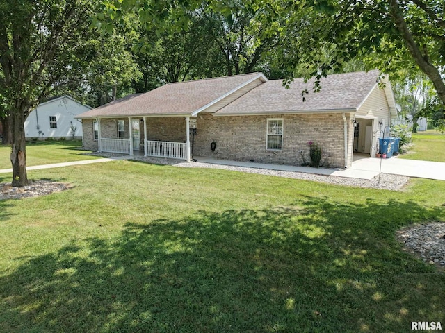 902 N Buchanan St, Benton, IL 62812 - ranch-style house with brick siding, a front lawn, a porch, and concrete driveway