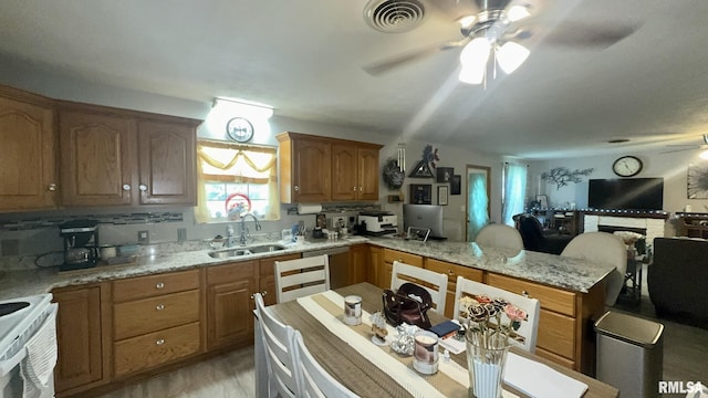 902 N Buchanan St, Benton, IL 62812 - kitchen with ceiling fan, a peninsula, white range with electric stovetop, and light stone countertops