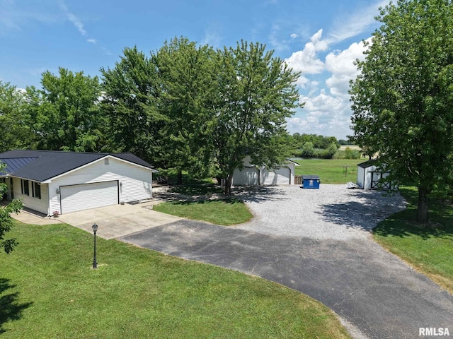 13919 Hamilton Pike Rd, Whittington, IL 62897 - view of front facade featuring driveway, a front yard, an outdoor structure, a metal roof, and an attached garage