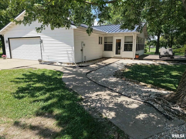 13919 Hamilton Pike Rd, Whittington, IL 62897 - view of front of house with a standing seam roof, a metal roof, a garage, concrete driveway, and a front lawn