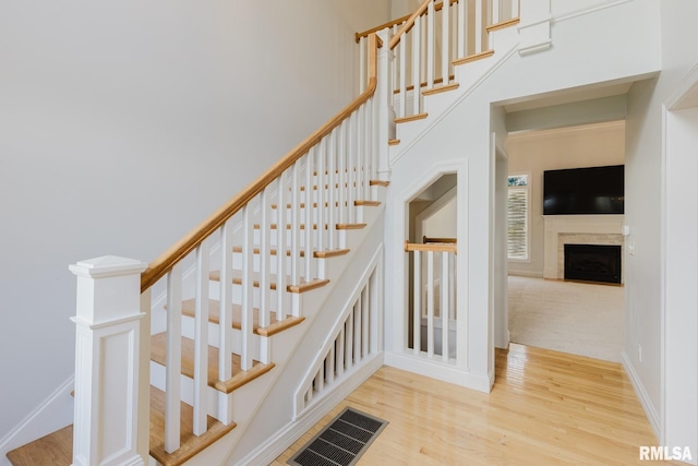 1506 Gleneagle Dr, Marion, IL 62959 - stairway with wood finished floors, a fireplace, and a towering ceiling