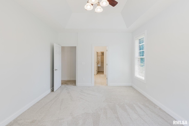 1506 Gleneagle Dr, Marion, IL 62959 - unfurnished bedroom with a tray ceiling, carpet floors, and a walk in closet