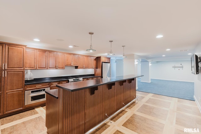 1506 Gleneagle Dr, Marion, IL 62959 - kitchen featuring appliances with stainless steel finishes, dark countertops, inlaid floor details, a kitchen bar, and recessed lighting